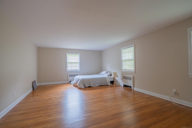 226 Stanwich Rd, Greenwich, CT 06830 - bedroom featuring wood finished floors and radiator