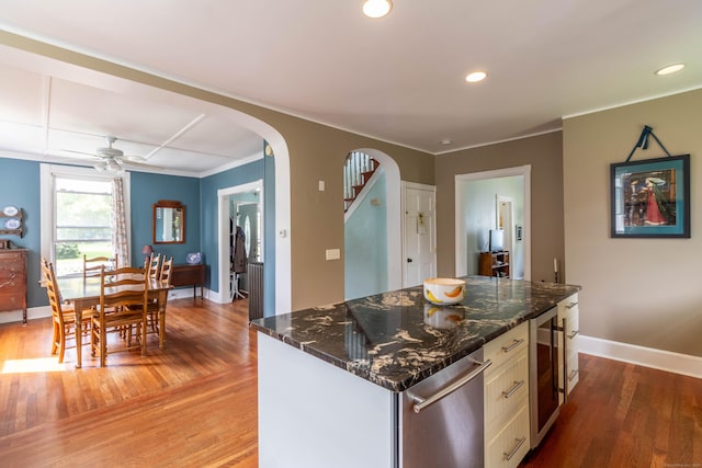 47 Silver St, Middletown, CT 06457 - kitchen with beverage cooler, arched walkways, light wood-style floors, white cabinetry, and recessed lighting