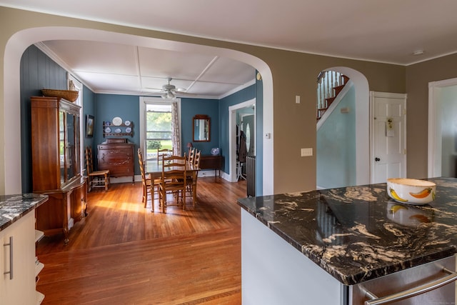 47 Silver St, Middletown, CT 06457 - kitchen with arched walkways, wood finished floors, crown molding, a ceiling fan, and dark stone countertops