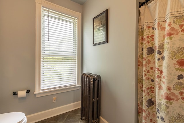 47 Silver St, Middletown, CT 06457 - full bathroom featuring radiator heating unit, tile patterned floors, healthy amount of natural light, and a shower with shower curtain
