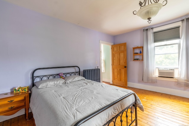 47 Silver St, Middletown, CT 06457 - bedroom with radiator heating unit, cooling unit, and wood-type flooring
