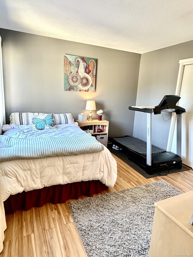 85 Viscount Dr Unit 4E, Milford, CT 06460 - bedroom with wood finished floors and a textured ceiling