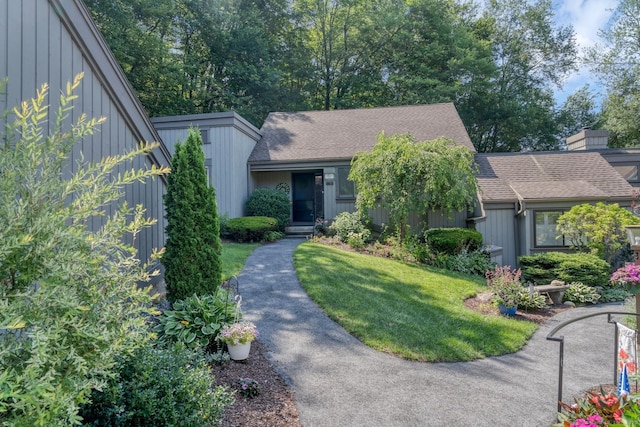 583 Heritage Vlg Unit A, Southbury, CT 06488 - mid-century inspired home with roof with shingles, a front yard, and board and batten siding