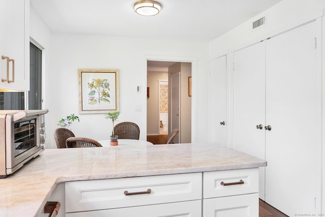 583 Heritage Vlg Unit A, Southbury, CT 06488 - kitchen with light stone counters and white cabinetry