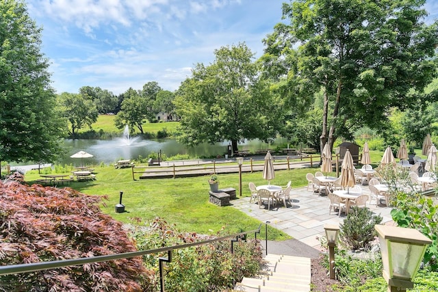 583 Heritage Vlg Unit A, Southbury, CT 06488 - view of grassy yard featuring a water view, a patio area, and view of scattered trees