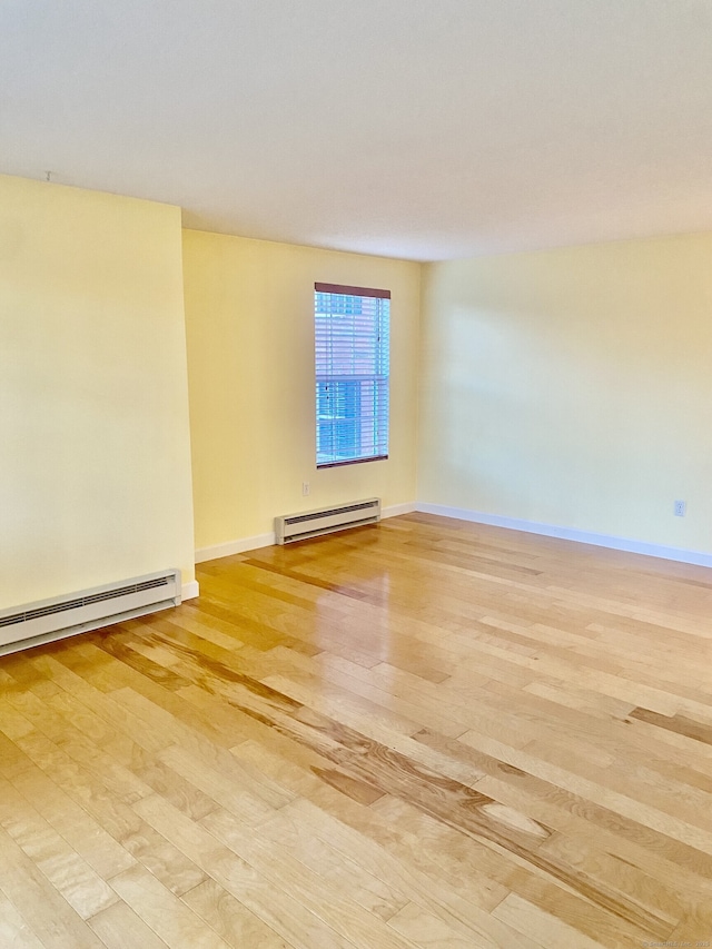 4 Heather Rdg Unit 4, Shelton, CT 06484 - empty room with light wood-style flooring and a baseboard heating unit