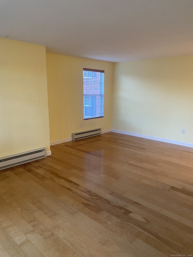 4 Heather Rdg Unit 4, Shelton, CT 06484 - spare room with light wood finished floors, baseboard heating, and a baseboard radiator