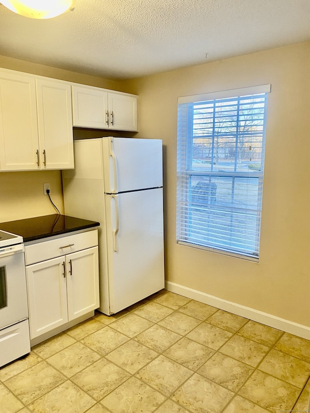 4 Heather Rdg Unit 4, Shelton, CT 06484 - kitchen with white appliances, white cabinetry, dark countertops, and a textured ceiling