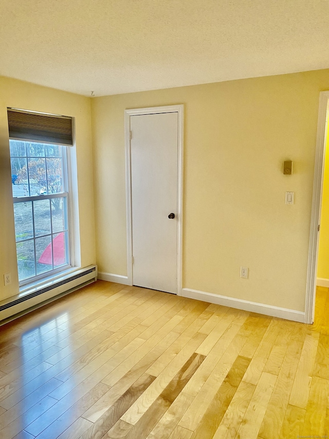 4 Heather Rdg Unit 4, Shelton, CT 06484 - empty room featuring baseboard heating and light wood-type flooring