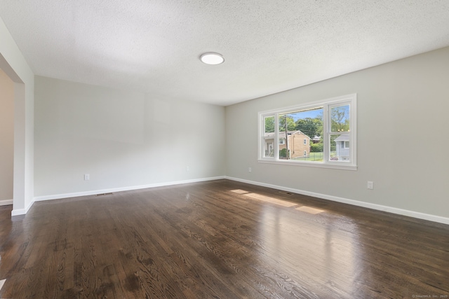 231 Lincolndale Dr, Waterbury, CT 06704 - unfurnished room with dark wood-type flooring and a textured ceiling