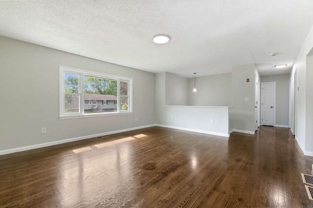 231 Lincolndale Dr, Waterbury, CT 06704 - spare room featuring dark wood-type flooring and a textured ceiling