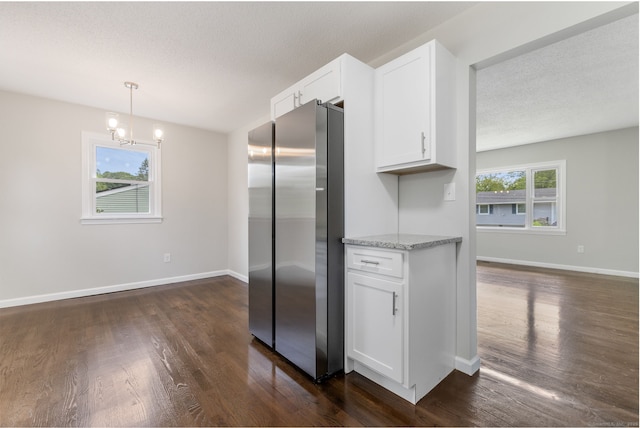 231 Lincolndale Dr, Waterbury, CT 06704 - kitchen featuring freestanding refrigerator, dark wood-type flooring, white cabinets, light stone counters, and a chandelier