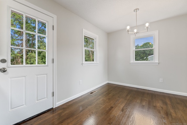 231 Lincolndale Dr, Waterbury, CT 06704 - unfurnished dining area featuring a chandelier, plenty of natural light, and dark wood-style flooring