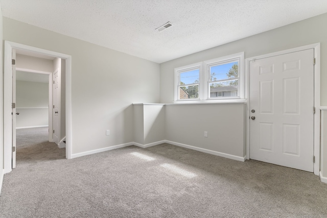 231 Lincolndale Dr, Waterbury, CT 06704 - carpeted empty room with a textured ceiling and baseboards