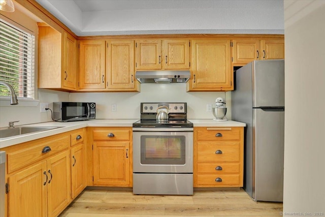 177 New Britain Ave Unit 177, Farmington, CT 06085 - kitchen with stainless steel appliances, under cabinet range hood, light countertops, and light wood finished floors