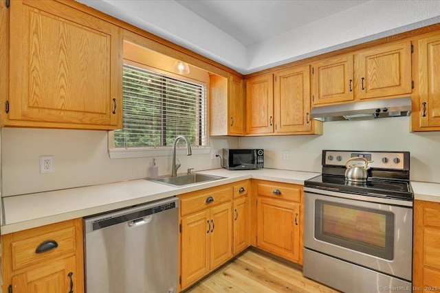 177 New Britain Ave Unit 177, Farmington, CT 06085 - kitchen with appliances with stainless steel finishes, under cabinet range hood, light wood finished floors, light countertops, and brown cabinets