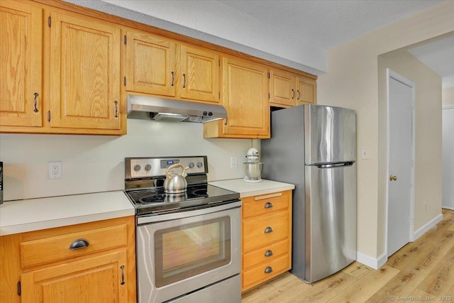 177 New Britain Ave Unit 177, Farmington, CT 06085 - kitchen featuring stainless steel appliances, under cabinet range hood, light wood finished floors, and light countertops