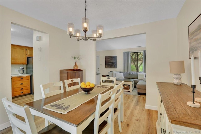 177 New Britain Ave Unit 177, Farmington, CT 06085 - dining area featuring a chandelier and light wood-style flooring