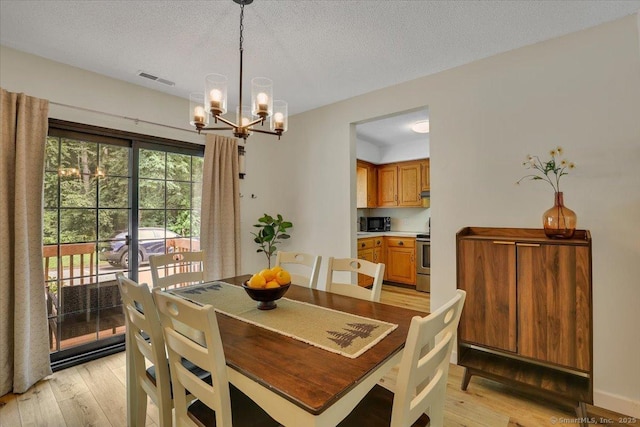 177 New Britain Ave Unit 177, Farmington, CT 06085 - dining space featuring a chandelier and light wood-style flooring