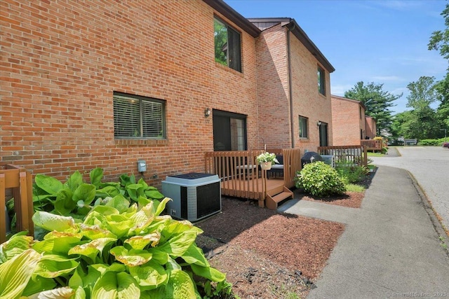 177 New Britain Ave Unit 177, Farmington, CT 06085 - view of side of home with a wooden deck and brick siding