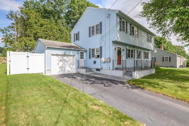 117 Woodside St, Putnam, CT 06260 - colonial inspired home featuring an attached garage, asphalt driveway, and a gate