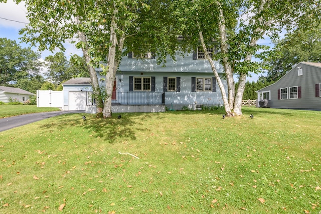 117 Woodside St, Putnam, CT 06260 - colonial-style house featuring a front yard, a garage, and driveway