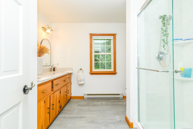 117 Woodside St, Putnam, CT 06260 - bathroom with a baseboard heating unit, vanity, wood finished floors, and a shower stall