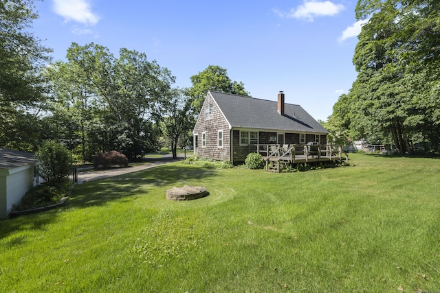 8 Nelson Dr, East Lyme, CT 06333 - view of green lawn with a wooden deck and driveway