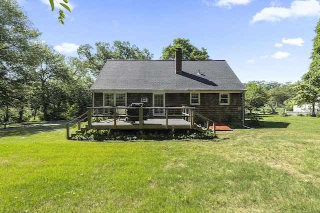 8 Nelson Dr, East Lyme, CT 06333 - back of property featuring a yard, a wooden deck, roof with shingles, and a chimney