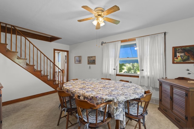 8 Nelson Dr, East Lyme, CT 06333 - dining room featuring light colored carpet, a ceiling fan, and stairs
