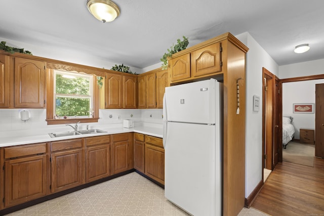 8 Nelson Dr, East Lyme, CT 06333 - kitchen featuring freestanding refrigerator, brown cabinetry, light countertops, and light flooring