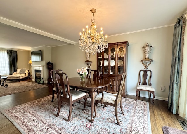 6005 Hancock Dr Unit 6005, Danbury, CT 06811 - dining area with a chandelier, wood finished floors, a glass covered fireplace, and ornamental molding