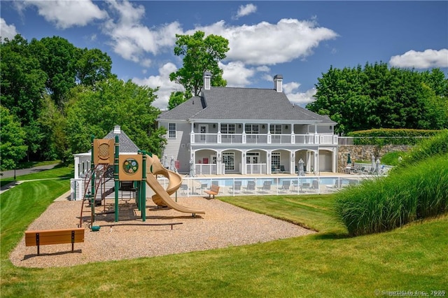 6005 Hancock Dr Unit 6005, Danbury, CT 06811 - back of property featuring a lawn, a balcony, and an outdoor pool