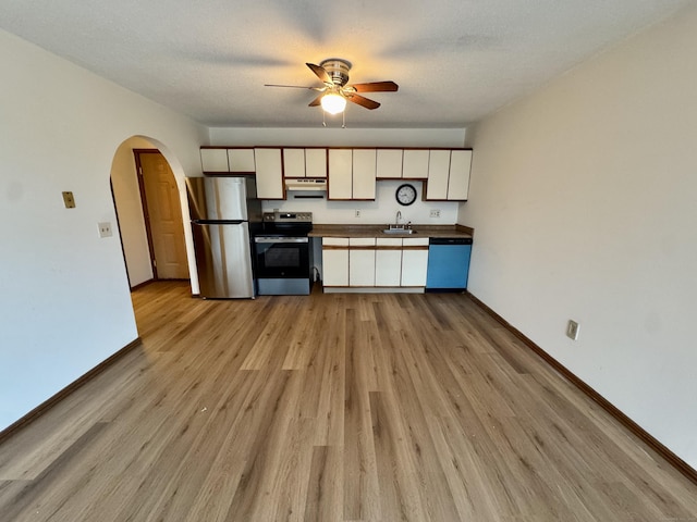 24 W Rd Apt 2, Ellington, CT 06029 - kitchen featuring stainless steel appliances, arched walkways, a ceiling fan, dark countertops, and light wood-type flooring