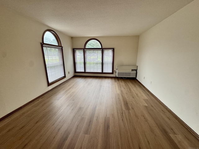 24 W Rd Apt 2, Ellington, CT 06029 - empty room with wood finished floors, a textured ceiling, and heating unit