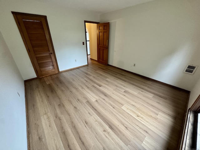 24 W Rd Apt 2, Ellington, CT 06029 - unfurnished bedroom featuring light wood-style flooring and freestanding refrigerator