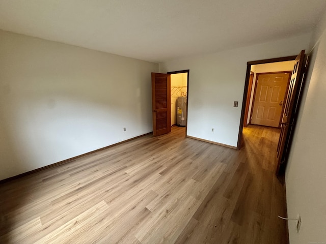 24 W Rd Apt 2, Ellington, CT 06029 - unfurnished bedroom featuring water heater, wood finished floors, and a spacious closet