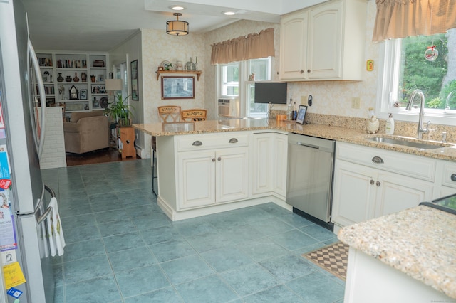 95 Holly Mar Hill Rd, North Branford, CT 06472 - kitchen featuring appliances with stainless steel finishes, a peninsula, wallpapered walls, plenty of natural light, and light stone countertops