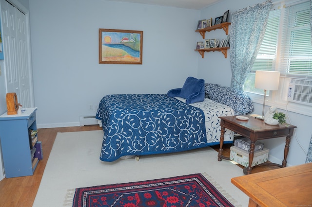 95 Holly Mar Hill Rd, North Branford, CT 06472 - bedroom featuring wood finished floors, a baseboard heating unit, and a closet