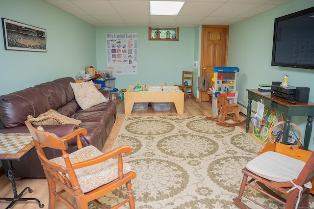 95 Holly Mar Hill Rd, North Branford, CT 06472 - living room with a paneled ceiling, wood finished floors, and a baseboard radiator