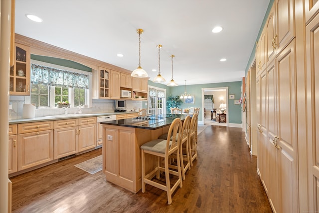 12 Marc Dr, Watertown, CT 06795 - kitchen featuring white appliances, glass insert cabinets, healthy amount of natural light, a kitchen breakfast bar, and recessed lighting
