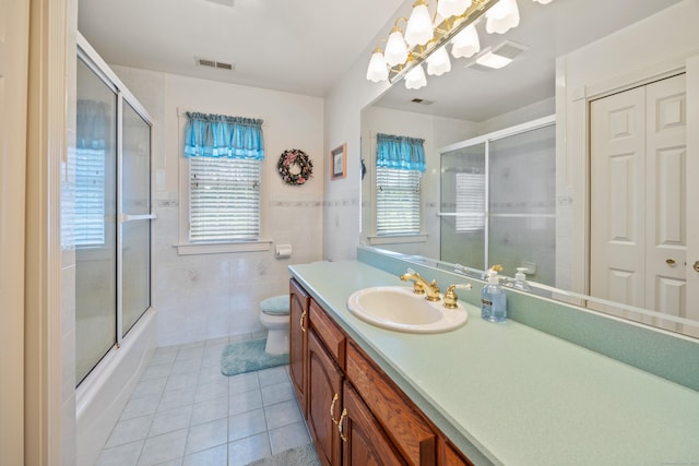 12 Marc Dr, Watertown, CT 06795 - bathroom featuring tile patterned flooring, vanity, tile walls, and combined bath / shower with glass door