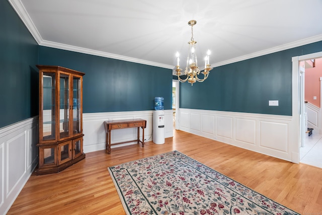 12 Marc Dr, Watertown, CT 06795 - dining space featuring a chandelier, wood finished floors, a wainscoted wall, and ornamental molding