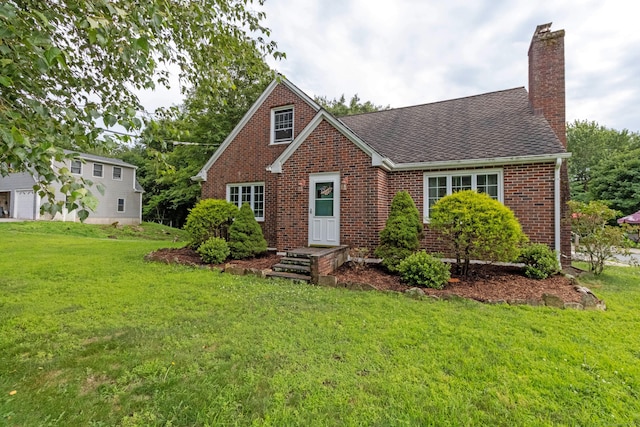 534 Norwich Ave, Colchester, CT 06415 - view of front facade featuring a chimney, brick siding, a front lawn, and a shingled roof