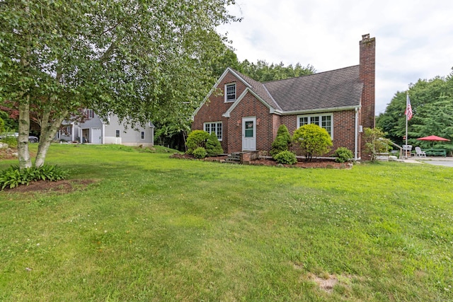 534 Norwich Ave, Colchester, CT 06415 - view of front facade featuring a chimney, brick siding, a front lawn, and roof with shingles