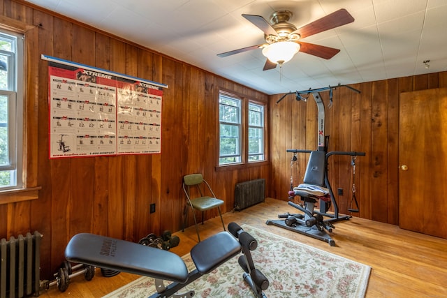 534 Norwich Ave, Colchester, CT 06415 - workout area featuring radiator heating unit, healthy amount of natural light, wood walls, and wood finished floors