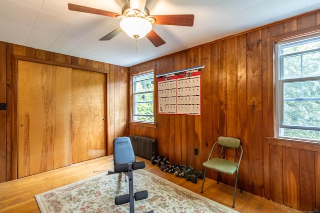 534 Norwich Ave, Colchester, CT 06415 - workout area with radiator heating unit, wooden walls, and wood finished floors