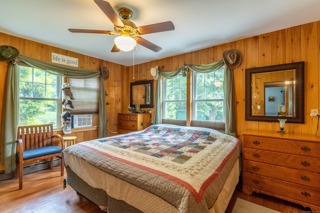 534 Norwich Ave, Colchester, CT 06415 - bedroom with wood walls, light wood-style floors, a ceiling fan, and cooling unit