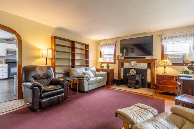 534 Norwich Ave, Colchester, CT 06415 - living room with a wood stove, plenty of natural light, arched walkways, and cooling unit