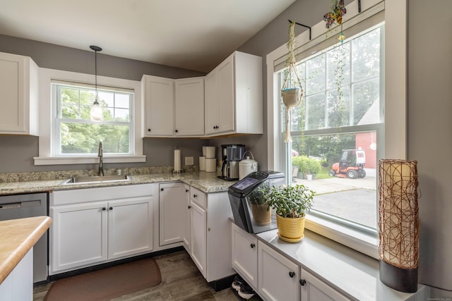 534 Norwich Ave, Colchester, CT 06415 - kitchen featuring dishwasher, white cabinets, light countertops, dark wood-style floors, and hanging light fixtures